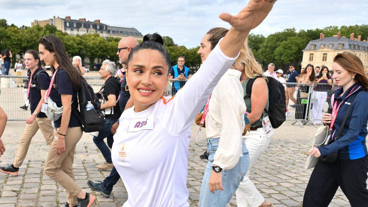Salma Hayek poses during the Paris Olympics torch relay on July 23, 2024 in Versailles, France. Paris will host the Summer Olympics from July 26 to August 11, 2024. Photo by Laurent Zabulon/Abaca/Sipa USA