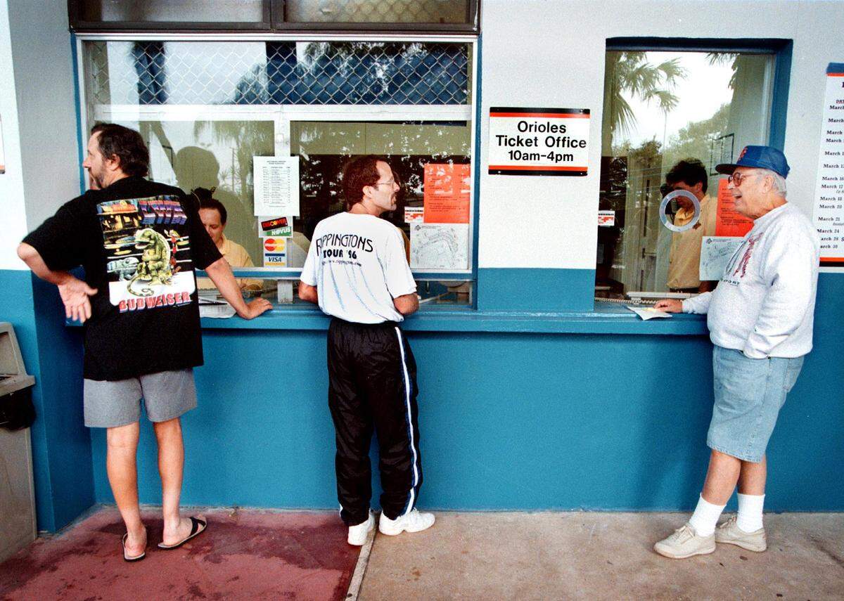 In Juanuary 199, left to right, George Gollis of Fort Lauderdale; Michael Prokop of Delray Beach; and Ralph Seid of Hallandale wait for the computers to come back online so they can buy tickets to the Baltimore Orioles spring training seaason. Gollis was the first person in line Saturday morning to buy the tickets. He said he arrived at Fort Lauderdale Stadium at 5:30 a.m., followed by Prokop and Seid. The computers went down shortly after 10 a.m. but soon came back up.