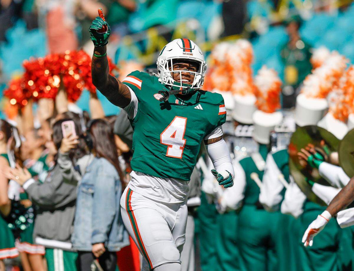 Miami Hurricanes running back Mark Fletcher Jr. (4) rushes onto the field for the start of the their NCAA game against the Wake Forest Demon Deacons in Miami Gardens, Florida, on Saturday, November 23, 2024.