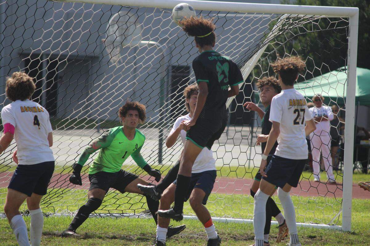Varela’s Juan Hernandez heads a shot on goal towards St. Thomas goalkeeper Ryan Rivas who made the save during Saturday’s Region 4-6A semifinal boys’ soccer game at Varela.