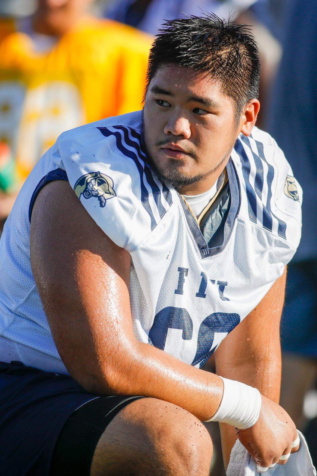 FIU center Ming Tjon (69) watches from the field during football practice at Florida International University in Miami, Florida, on Tuesday, August 16, 2022.