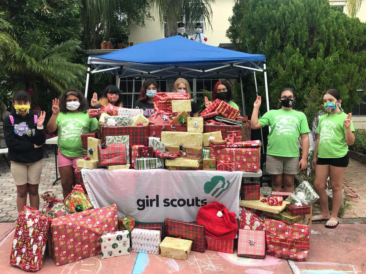 These Girl Scouts wrapped presents for the children of families they have been helping with food donations for seven months. From left, are Candice Mitchell, Leanni Cedeno, Florencia Jaimes, Angela Hernandez Raidot, Mila Stendel, Camila Rodriguez, Melanie Toledo, and Naomi Nelson. Not in the picture, who also packed, are Faith Welsh, Amora Farah, Caley Corneille, and Mila Panos.