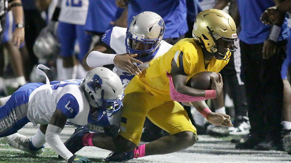 St. Thomas Aquinas Raiders quarterback Zion Turner is taken down by Dillard Panthers defenders during football game Friday, October 22, 2021 at St. Thomas Aquinas HS in Fort Lauderdale