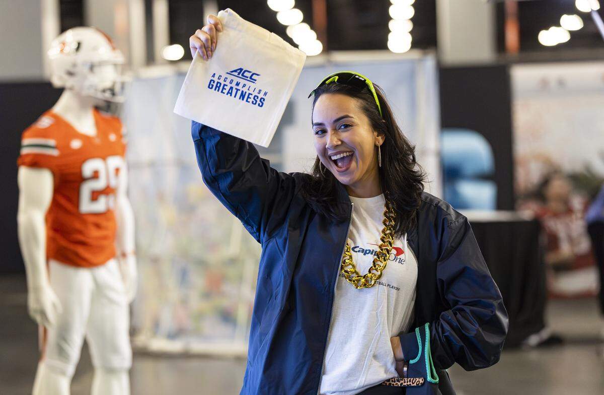 Yudy Cores strikes a pose as she visits the Playoff Fan Central at the Miami Beach Convention Center on Friday, Jan. 16, 2025, in Miami Beach, Fla. Fans can visit the event ahead of the College Football Playoff National Championship Game between the Miami Hurricanes and the Indiana Hoosiers and enjoy a variety of family-friendly interactive experiences.