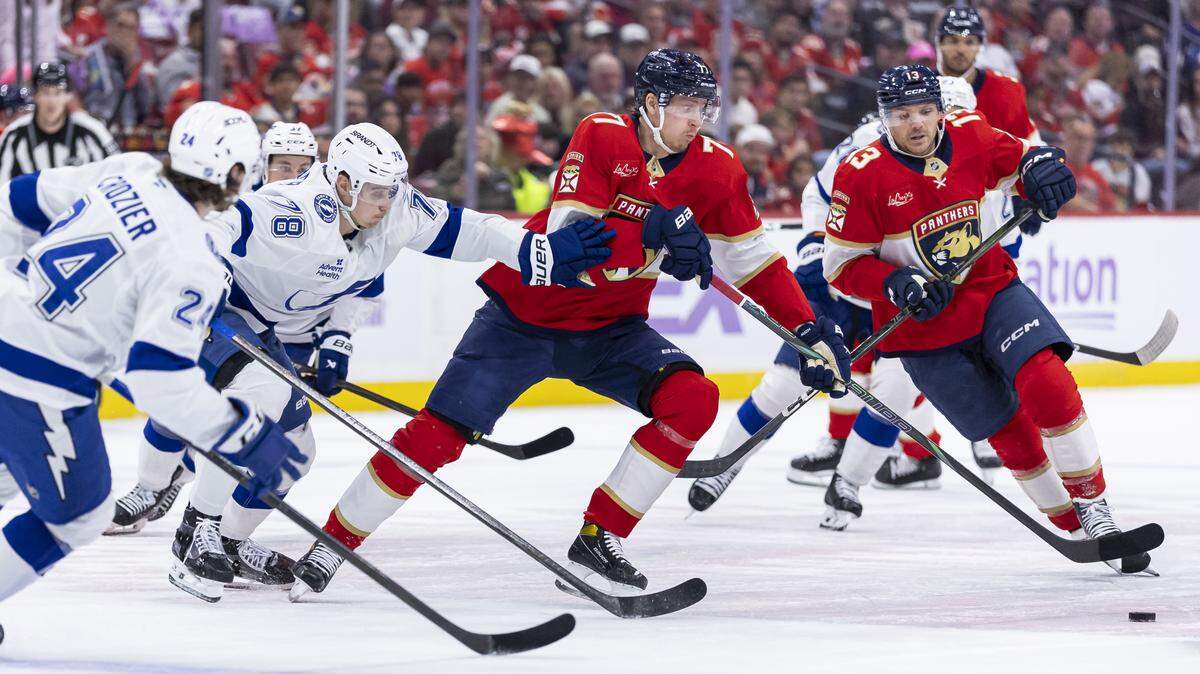 Florida Panthers defenseman Niko Mikkola (77) and Tampa Bay Lightning defenseman Emil Lilleberg (78) compete for the puck in the first period of their NHL game at the Amerant Bank Arena on Saturday, Nov. 15, 2025, in Sunrise, Fla.