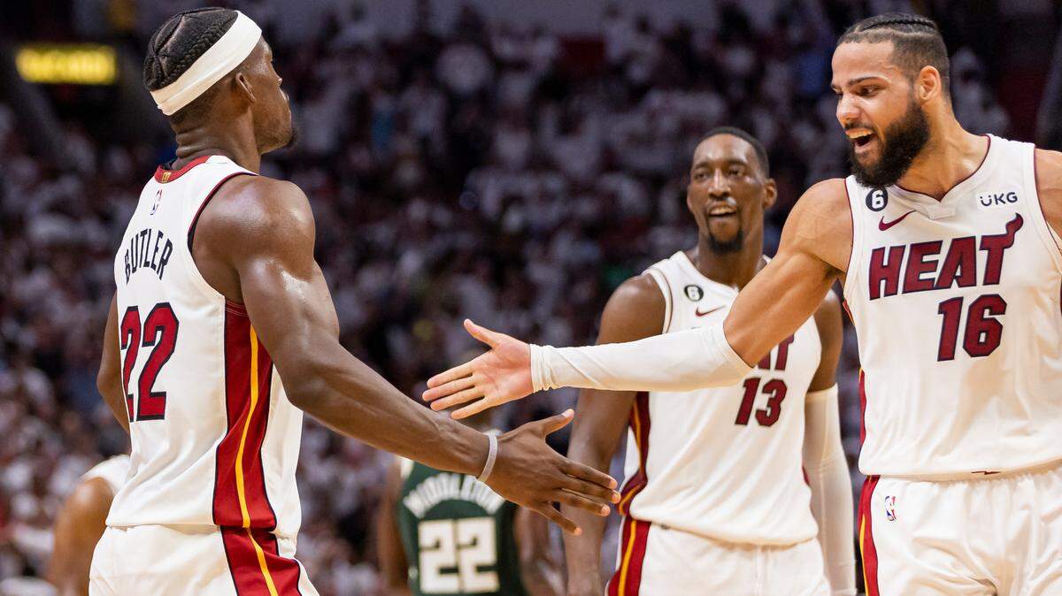 Miami Heat forwards Jimmy Butler (22) and Caleb Martin (16) celebrate after scoring against the Milwaukee Bucks during the fourth quarter of Game 4 in the first-round NBA basketball playoff series at Kaseya Center on Monday, April 24, 2023, in Miami.