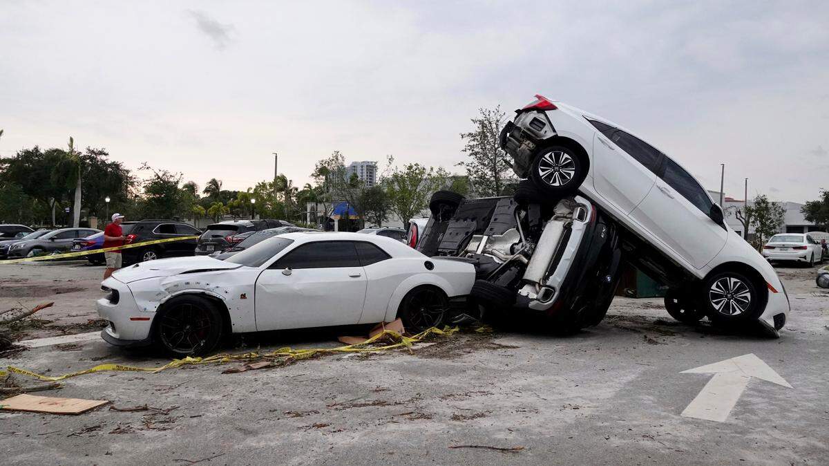 Damaged cars appear in a parking lot after a reported tornado hit the area Sunday, April 30, 2023 in Palm Beach Gardens, Fla. (Joe Cavaretta/South Florida Sun-Sentinel via AP)