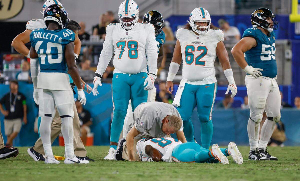 Miami Dolphins head athletic trainer Kyle Johnston arrives to check on Miami Dolphins wide receiver Daewood Davis (87) after being injured during the game against the Jacksonville Jaguars at EverBank in Jacksonville, Florida on Saturday, August 26, 2023.