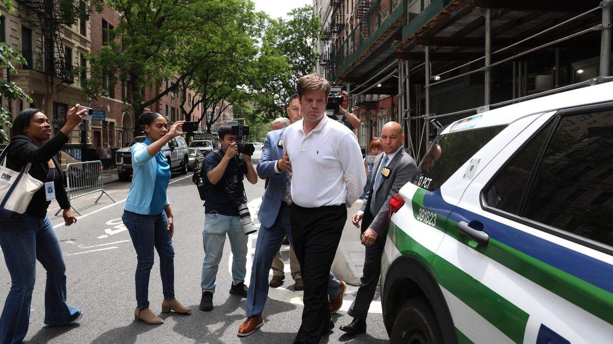 William Duplessie is walked out of the 13th Precinct in handcuffs in New York, on Tuesday, May 27, 2025. A third person accused of kidnapping a man and torturing him for nearly three weeks to steal his Bitcoin fortune surrendered to the police on Tuesday morning, said Police Commissioner Jessica S. Tisch. (Jefferson Siegel/The New York Times)
