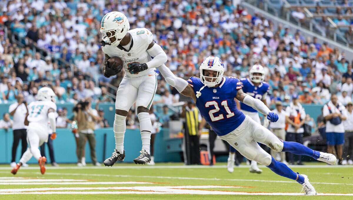 Miami Dolphins wide receiver Malik Washington (6) catches a touchdown pass as Buffalo Bills safety Jordan Poyer (21) fails to stop him in the first half of their NFL game at Hard Rock Stadium on Sunday, Nov. 9, 2025, in Miami Gardens, Fla.