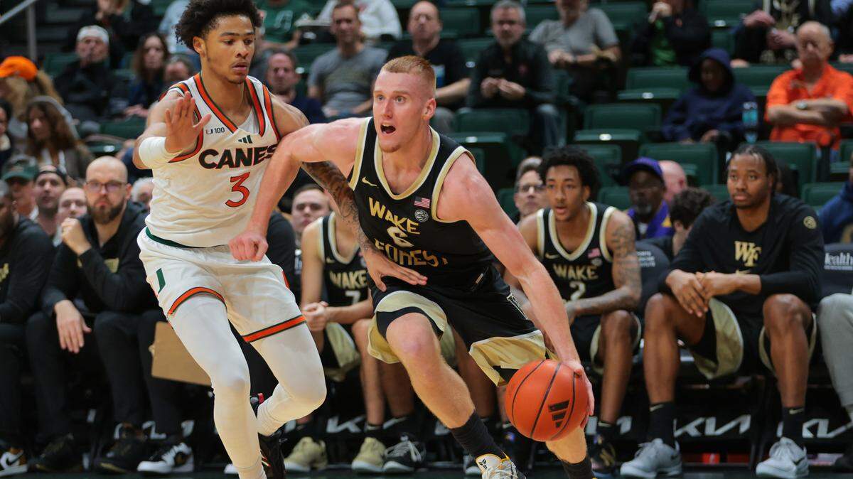 Jan 11, 2025; Coral Gables, Florida, USA; Wake Forest Demon Deacons guard Cameron Hildreth (6) drives to the basket past Miami Hurricanes guard Jalil Bethea (3) during the second half at Watsco Center. Mandatory Credit: Sam Navarro-Imagn Images