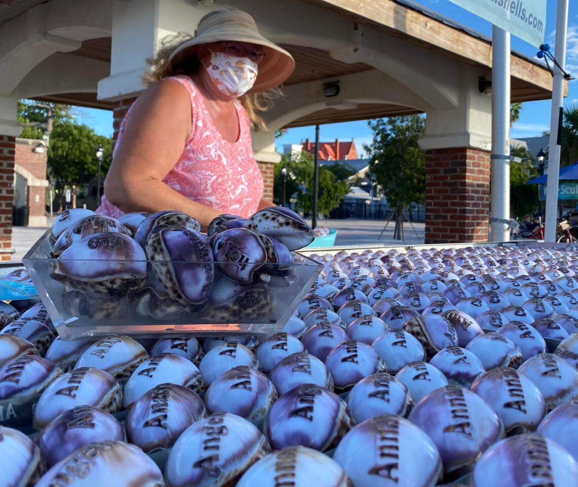 Linda McCall sells personalized name shells at Mallory Square in Key West during the Sunset Celebration festival.