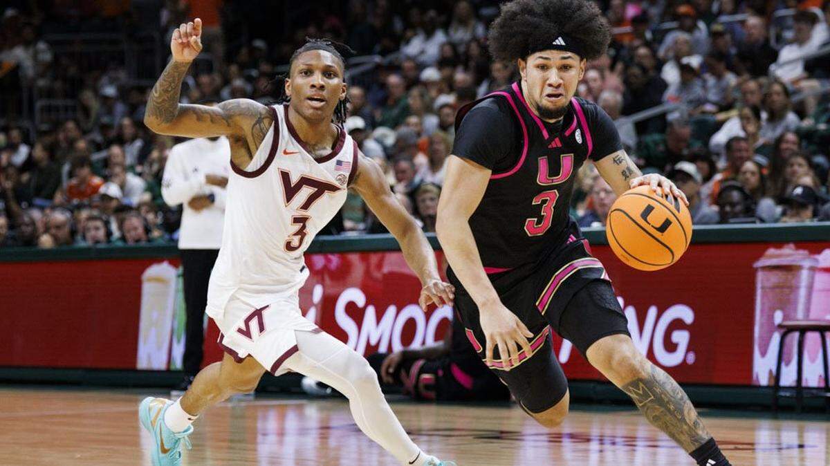 Miami Hurricanes guard Tre Donaldson (3) dribbles around Virginia Tech Hokies guard Ben Hammond (3) during the first half of a game on Tuesday, Feb. 17, 2026, at the Watsco Center in Coral Gables, Fla.