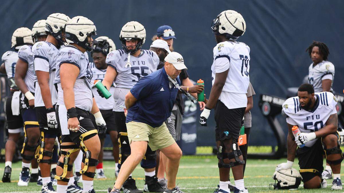 FIU Golden Panthers offensive line coach Joshua Eargle works with players during football practice at Florida International University in Miami, Florida, Thursday, March 28, 2024.