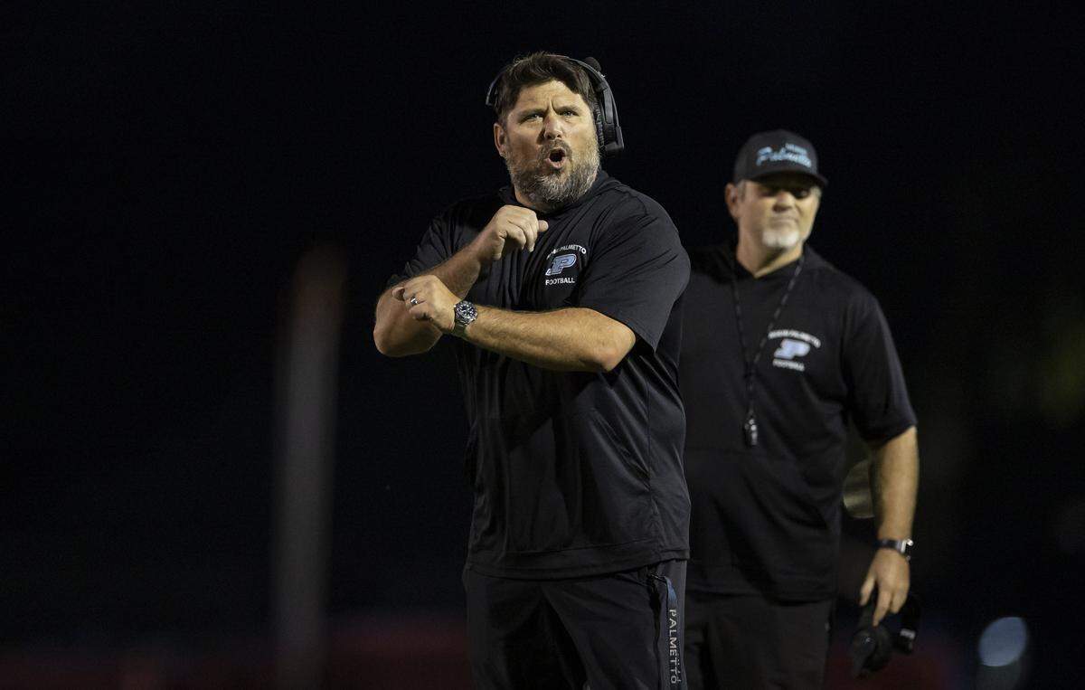 Palmetto Panthers head coach Michael Manasco reacts after a play against the Columbus Explorers in the first half of their Region 4-7A quarterfinal high school football playoff game at Tropical Park on Friday, Nov. 21, 2025, in Miami, Fla.