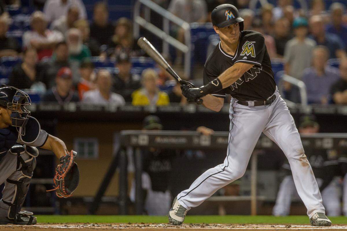 Miami Marlins catcher J.T. Realmuto (11) hits and infield single against the Washington Nationals  during the first inning of the game at Marlins Park in Miami on Saturday, May 26, 2018.