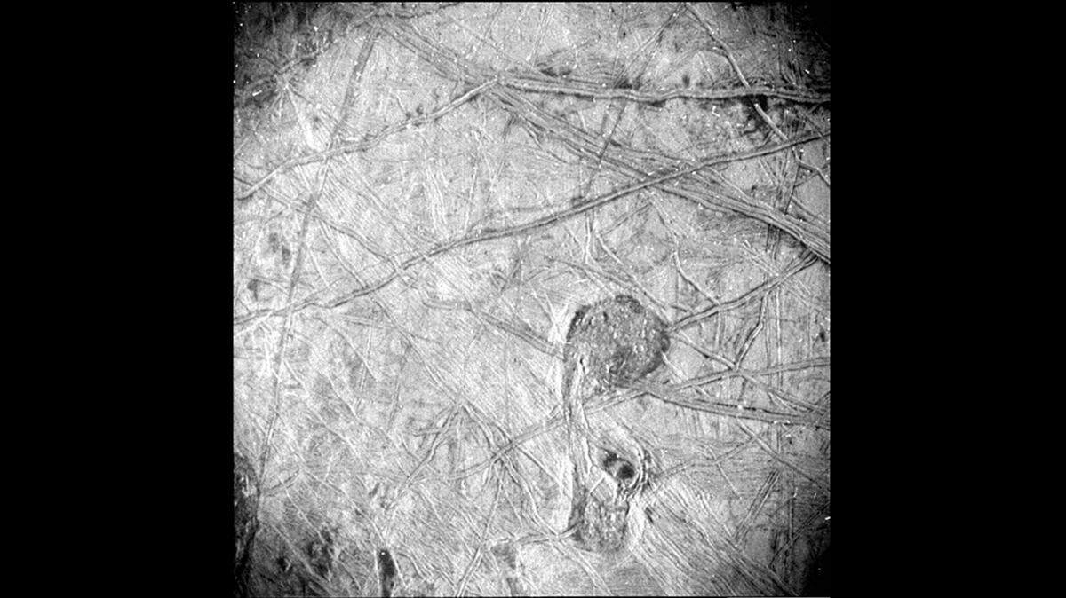 New high-resolution photos of Jupiter’s icy moon Europa show the surface is covered with something resembling roads rather than craters, and they go on for miles.