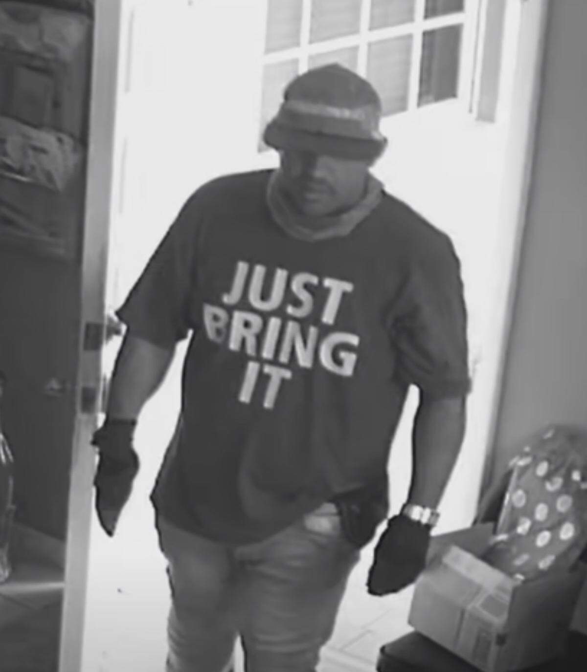 A man who city of Miami police say burglarized a home on Monday, Jan. 23, 2023, is seen wearing a T-shirt that reads ‘Just Bring It.’