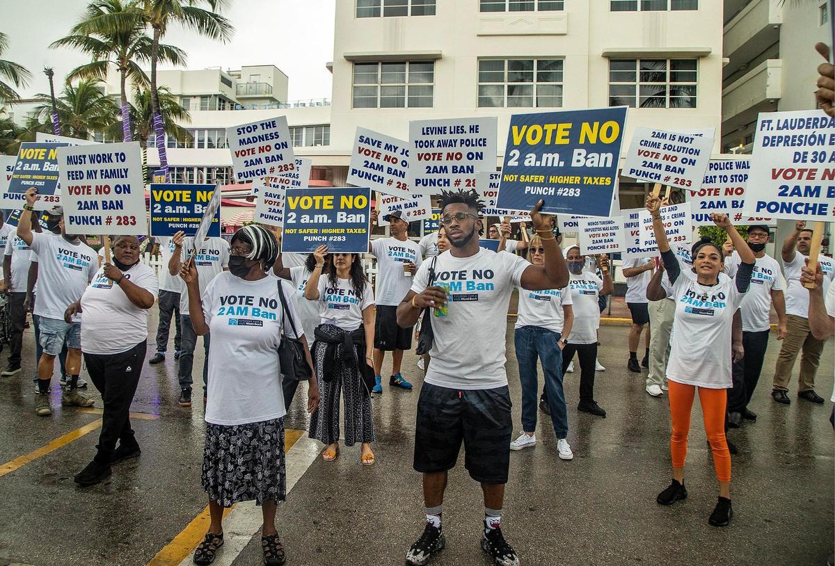 Protesters gather in South Beach ahead of a press conference held by Miami Beach Mayor Dan Gelber and former Mayor Philip Levine at the corner of Ocean Drive and 10th Street in Miami Beach on Friday, Oct. 22, 2021. The protesters, who said they are hospitality workers, shouted their opposition to a proposed 2 a.m. ban on alcohol sales that Gelber has proposed. Gelber and former Miami Beach Mayor Philip Levine held the press conference to promote a citywide referendum on the Nov. 2 ballot that asks voters whether the city should ban alcohol sales after 2 a.m. at certain late-night businesses.