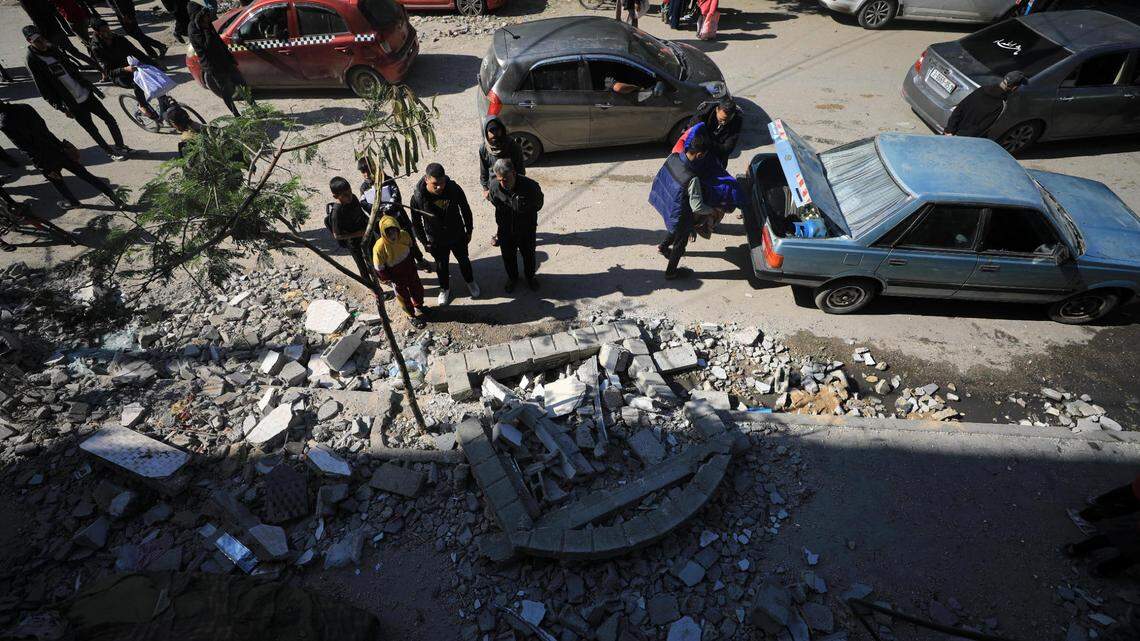 People inspect the damage after an Israeli airstrike in the southern Gaza Strip city of Rafah, on Jan. 25.