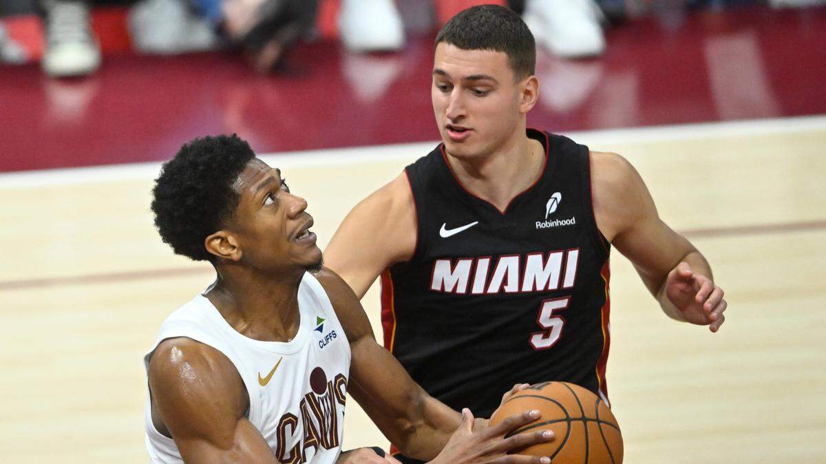 Cleveland Cavaliers forward De’Andre Hunter (12) looks to the basket beside Miami Heat forward Nikola Jovic (5) in the fourth quarter of Game 2 of their 2025 first-round playoff series at Rocket Arena.