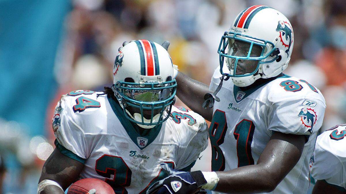 After a touchdown in his first Dolphins regular season game, Sept. 8, 2002, running back Ricky Williams is congratulated by Randy McMichael, who the Dolphins drafted with the fourth round pick that came from New Orleans in the trade for Willliams.