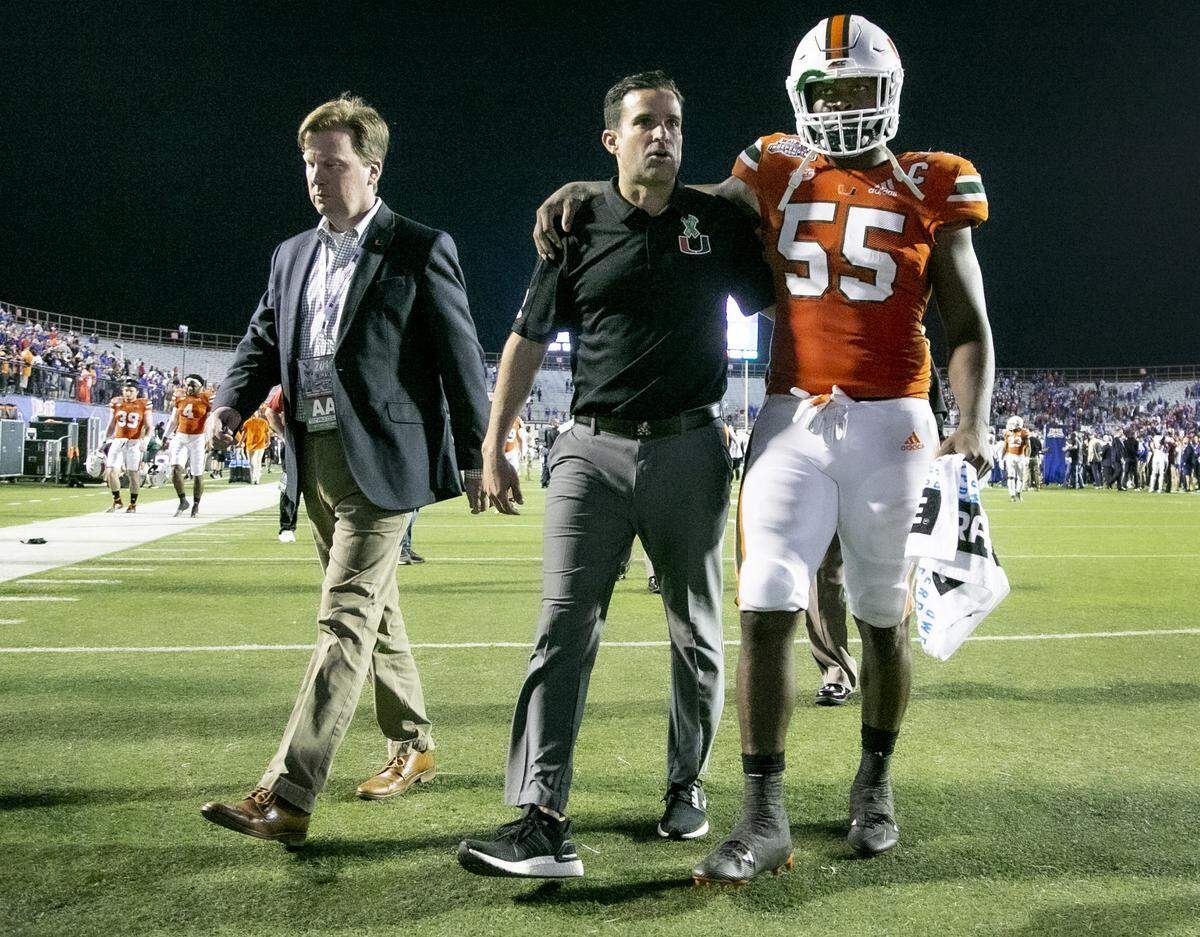 Miami Hurricanes head coach Manny Diaz walks off the field with linebacker Shaquille Quarterman (55) after the Miami Hurricanes lose to Louisiana Tech 14-0 in the Walk On’s Independence Bowl at Independence Stadium, Shreveport, Louisiana on Thursday, December 26, 2019.