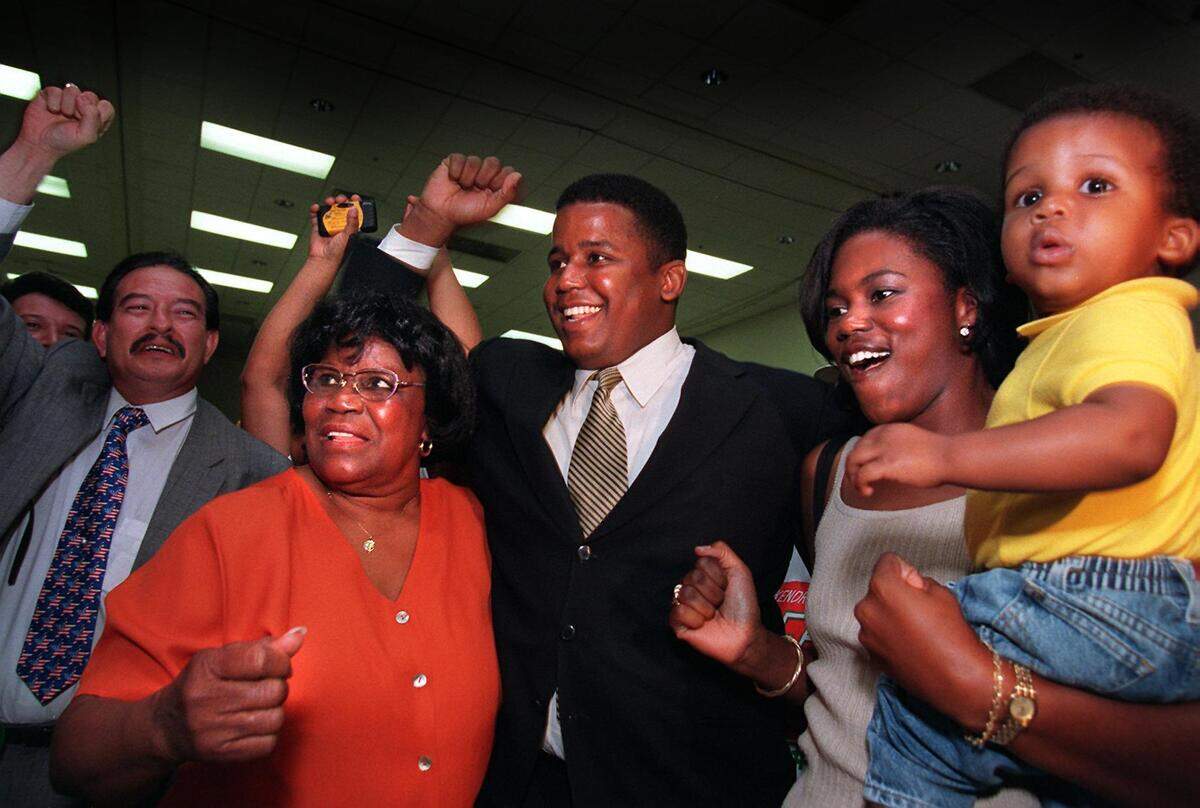 9/1/98--PHOTO BY JON KRAL--LOCAL--The Meek Family--L to R--U.S. Representative Carrie P. Meek and son Kendrick Meek His wife Leslie Meek and son Kendreck Meek Jr. One year old. At a victory party held at the Caleb Center.
