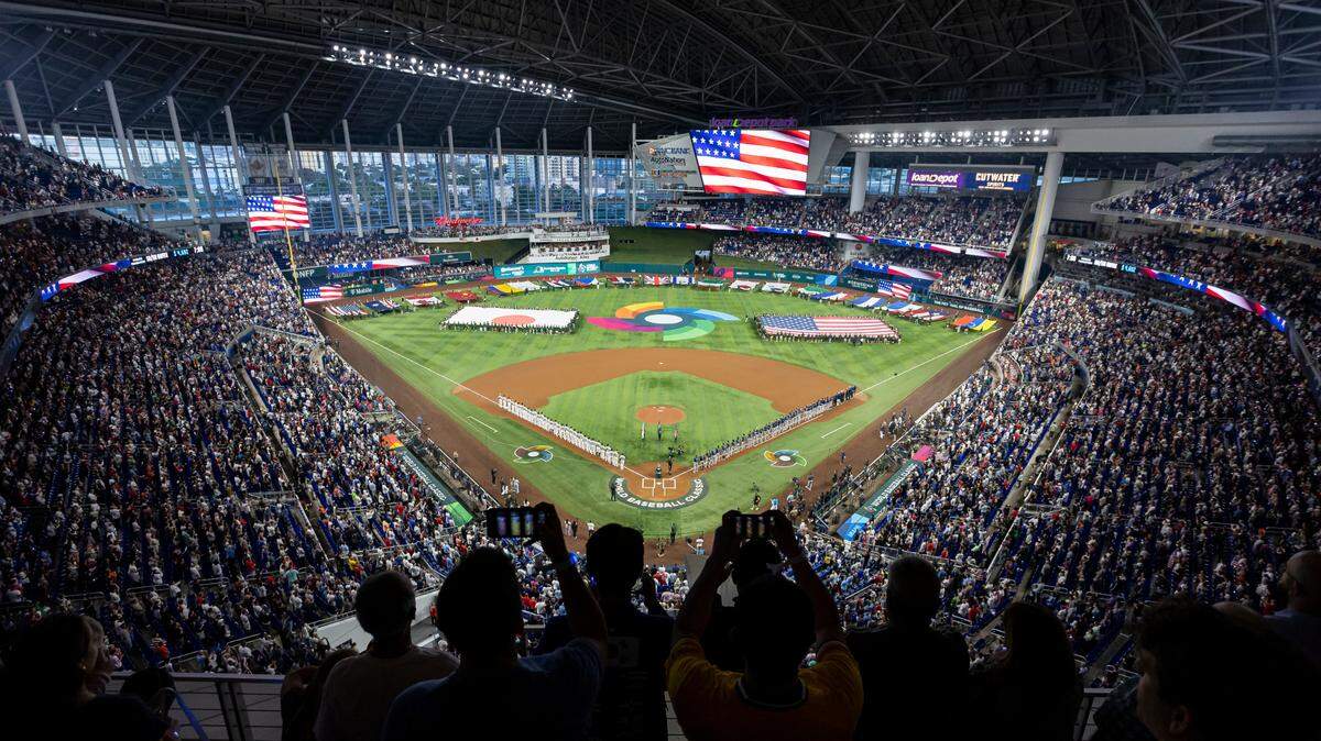 Fans stand for the national anthem before the start of a championship game between USA and Japan at the World Baseball Classic at loanDepot Park on Tuesday, March 21, 2023, in Miami, Fla.