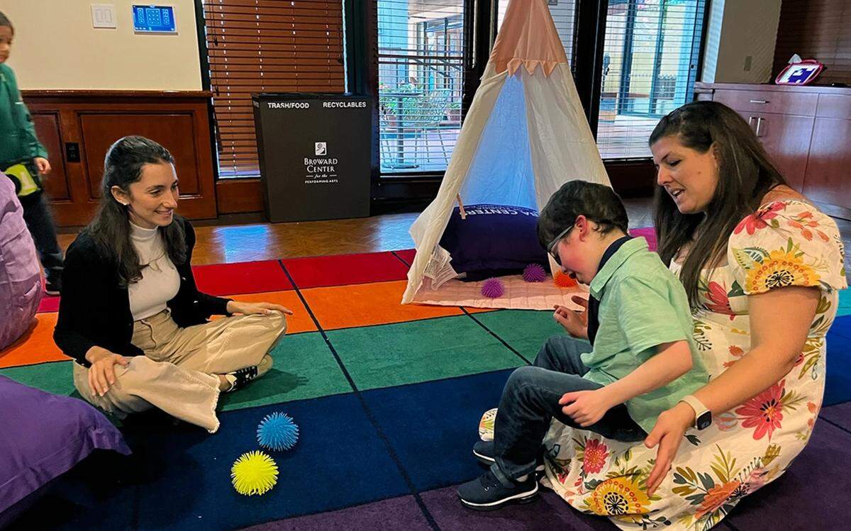 Georgette Kores sings to her son Benjamin, 8, in a sensory room at the Broward Center for the Performing Arts on Dec. 6, 2025.