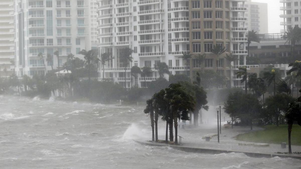 In this Sept. 10, 2017, photo, waves crash over a seawall at the mouth of the Miami River from Biscayne Bay as Hurricane Irma passes by in Miami.