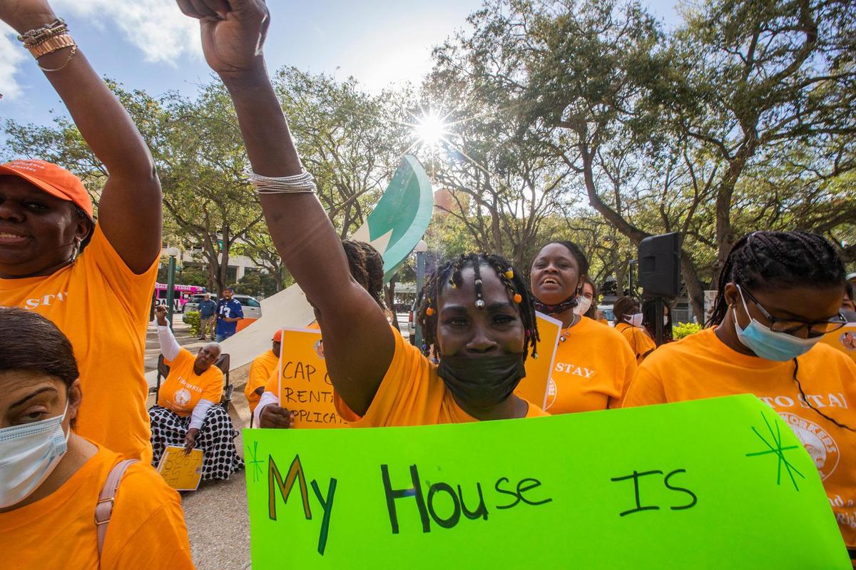 Janie Jackson holds a sign at the protest on Tuesday, March 8, 2022.