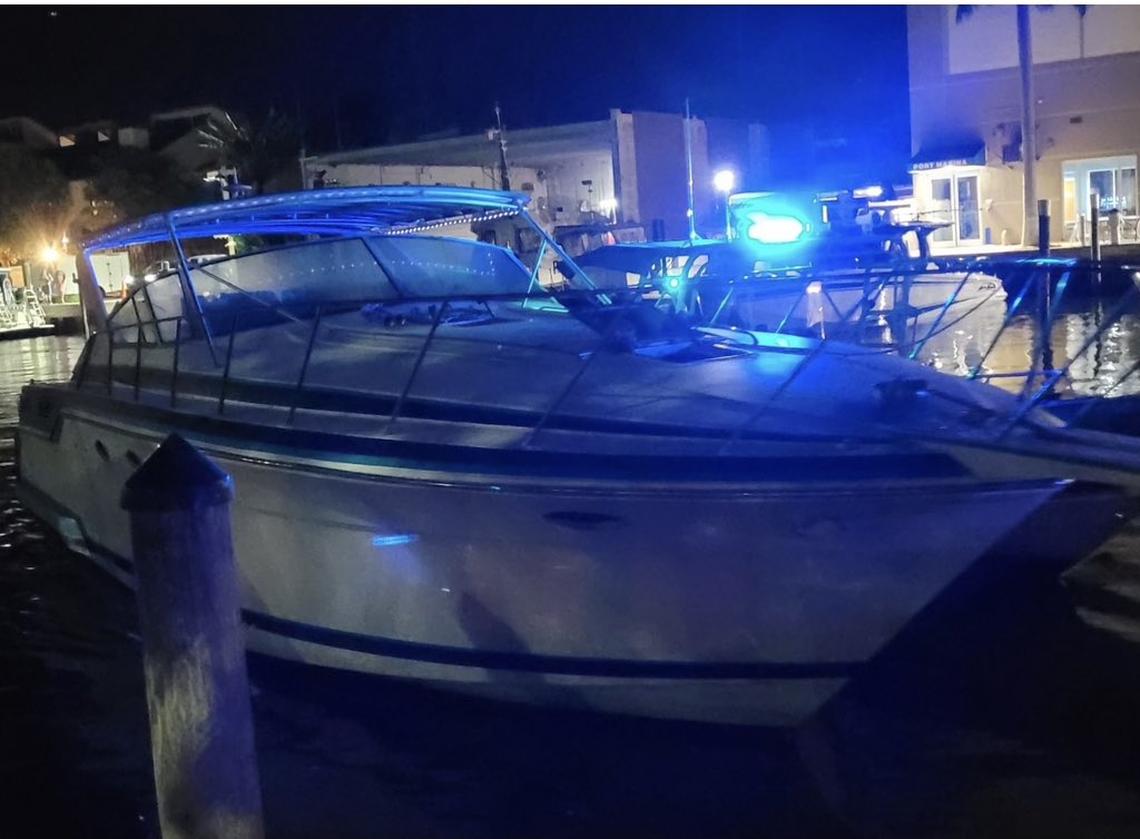 A yacht that U.S. Border Patrol says brought a dozen migrants to a Fort Lauderdale beach is docked at a marina Tuesday night, Jan. 10, 2022.