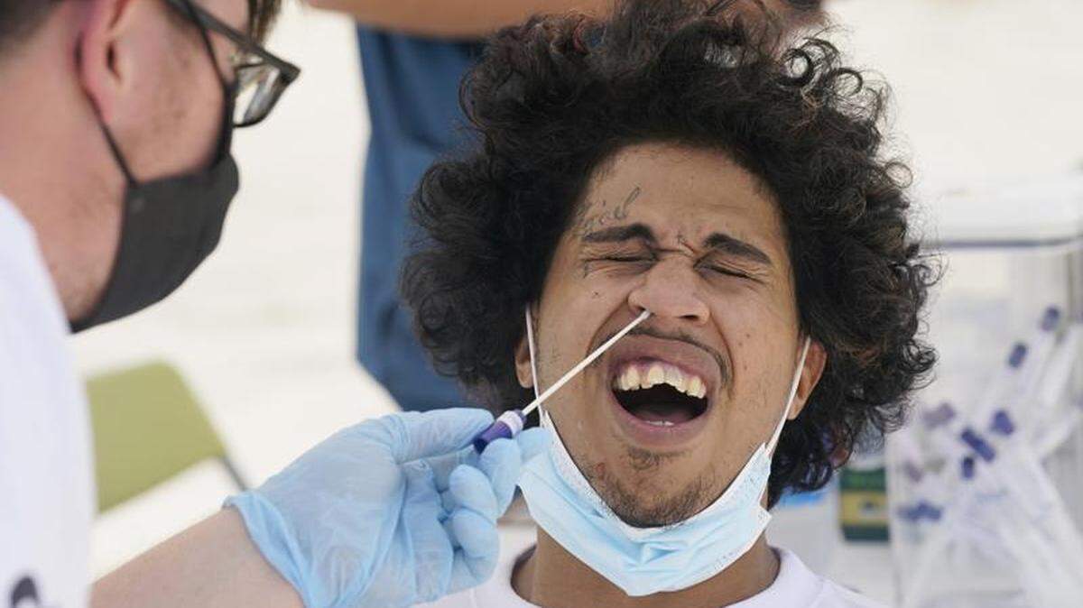 Benny Luna, of Miami, gets tested for COVID-19. The number of cases in Florida has surged.