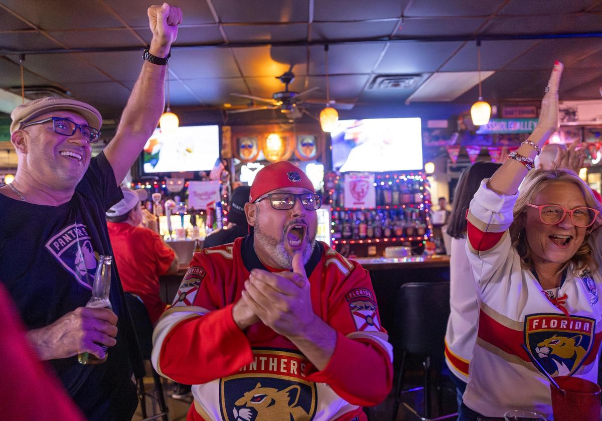 Florida Panthers fan Joe Hernandez, center, cheers after his team scored against the Edmonton Oilers in Game 2 of the NHL Stanley Cup Final at the Inn Field Bar & Grill on Friday, June 6, 2025, in Sunrise, Fla.