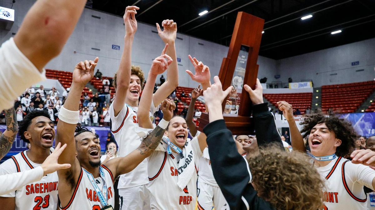 Sagemont teammates react as the State Championship Trophy is lifted in the air after defeating Victory Christian Academy during boy’s 1A basketball State Final of the Florida High School State Championships at the RP Funding Center in Lakeland, Florida on Thursday, February 27, 2025.