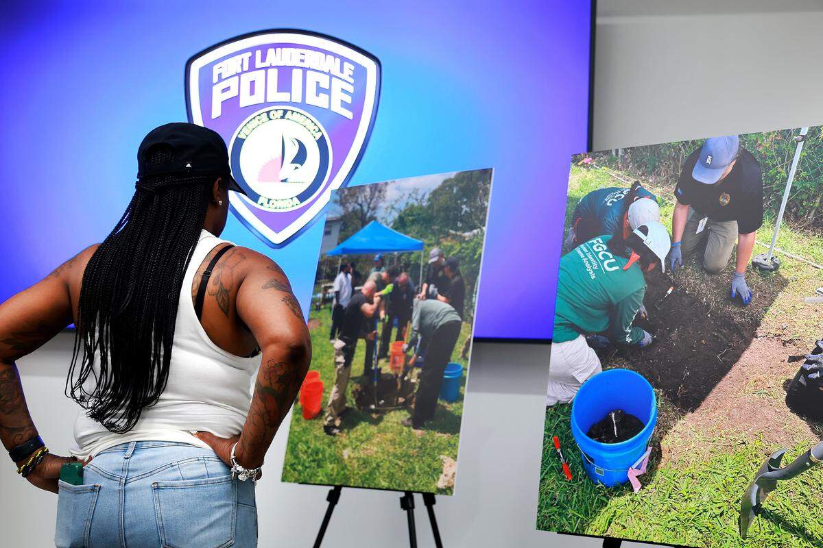Lynnette Finnie looks at a display showing photos of the recovery process of the remains of her niece, Trukita Scott. Finnie was at a press conference at the Fort Lauderdale Police Department on Tuesday, May 19, 2026. 