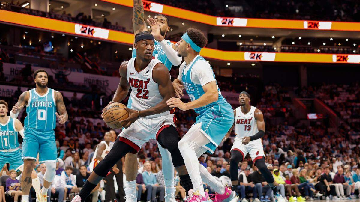 Miami Heat forward Jimmy Butler (22) looks to pass against Charlotte Hornets guard Seth Curry (30) and center Nick Richards (4) during the first quarter at Spectrum Center.