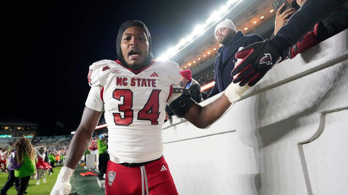 Nov 30, 2024; Chapel Hill, North Carolina, USA; North Carolina State Wolfpack linebacker Kamal Bonner (34) celebrates after the game at Kenan Memorial Stadium. Mandatory Credit: Bob Donnan-Imagn Images