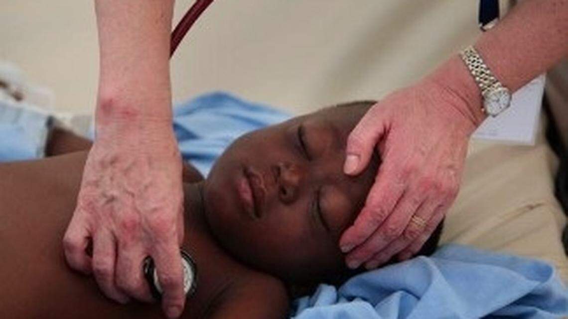 In 2010, a doctor examines a boy thought to have contracted malaria in Port-au-Prince, Haiti.