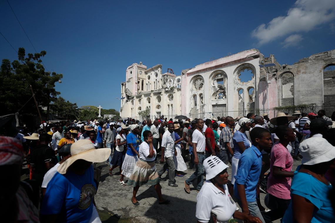 People walk past Notre Dame Cathedral, destroyed in the 2010 earthquake, during a march called by religious leaders in Port-au-Prince, Haiti, Tuesday, Oct. 22, 2019. While large groups of marchers sang religious songs and prayed, many also chanted political slogans calling for the resignation of President Jovenel Moise, including “Jovenel must go,” and “Too much blood has been spilled.”