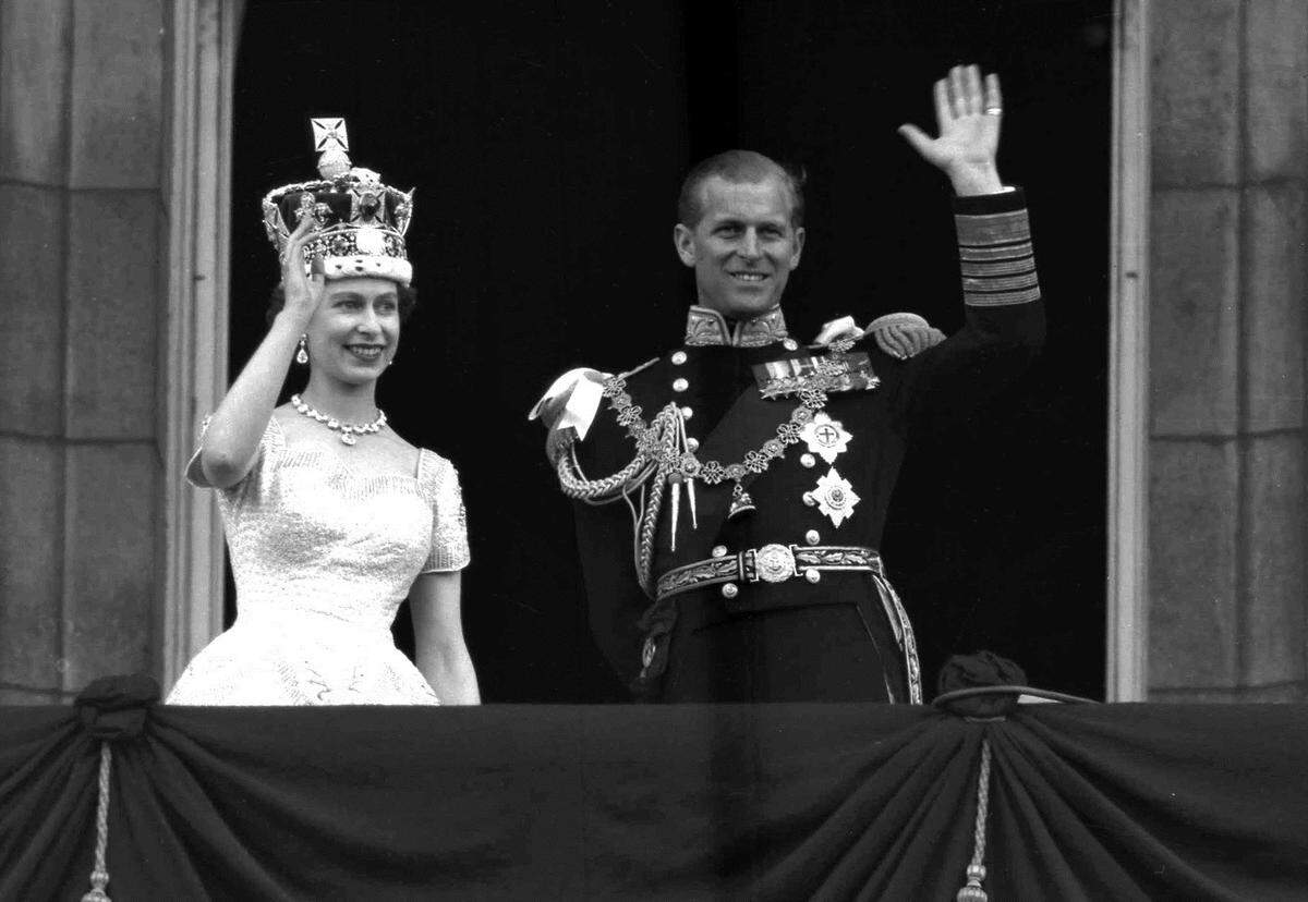 FILE - In this June. 2, 1953 file photo, Britain’s Queen Elizabeth II and Prince Philip, Duke of Edinburgh wave to supporters from the balcony at Buckingham Palace, following her coronation at Westminster Abbey, London. Queen Elizabeth II, Britain’s longest-reigning monarch and a rock of stability across much of a turbulent century, has died. She was 96. Buckingham Palace made the announcement in a statement on Thursday Sept. 8, 2022. (AP Photo/Leslie Priest, File)