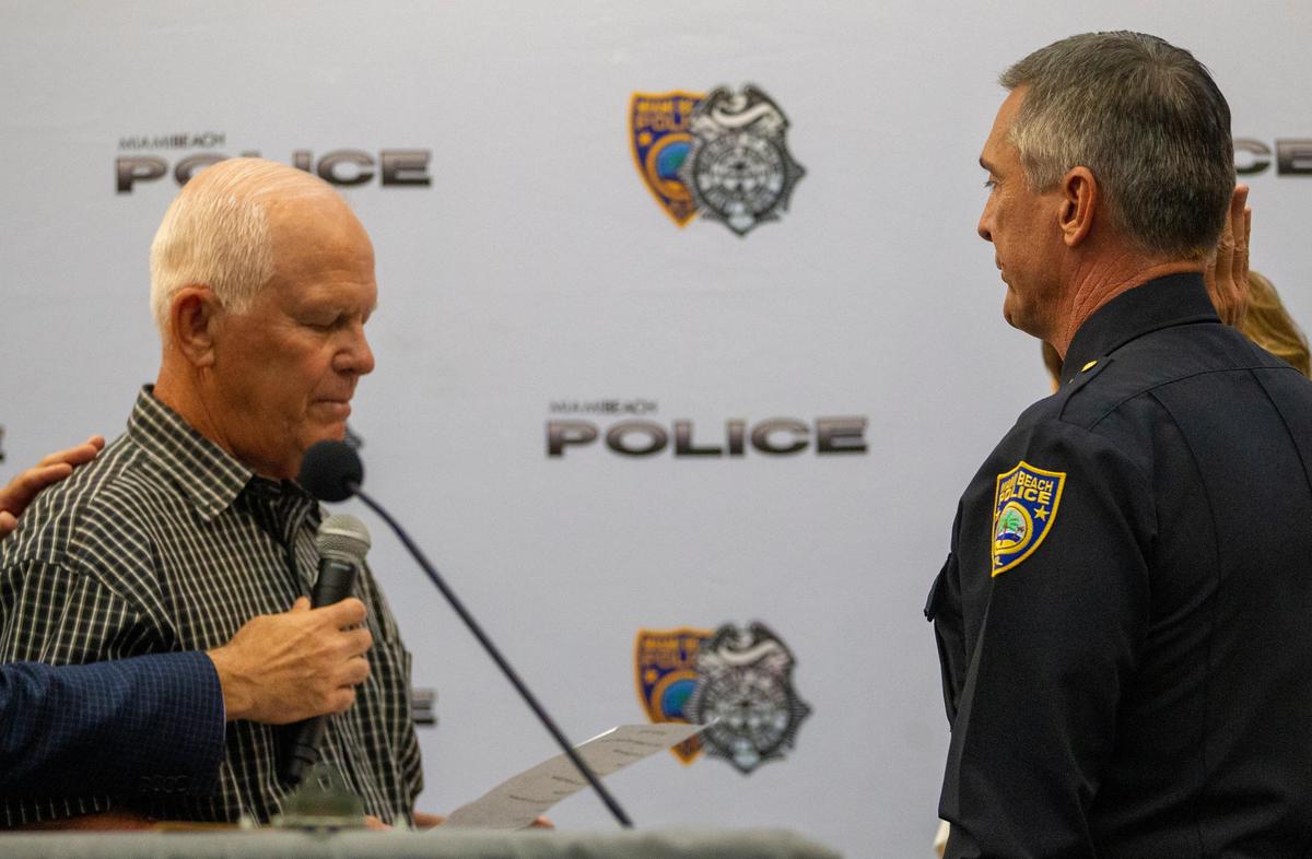 John Clements, left, recites the oath of office to his son and new Miami Beach Police Chief, Richard Clements, at Monday’s swearing-in ceremony.