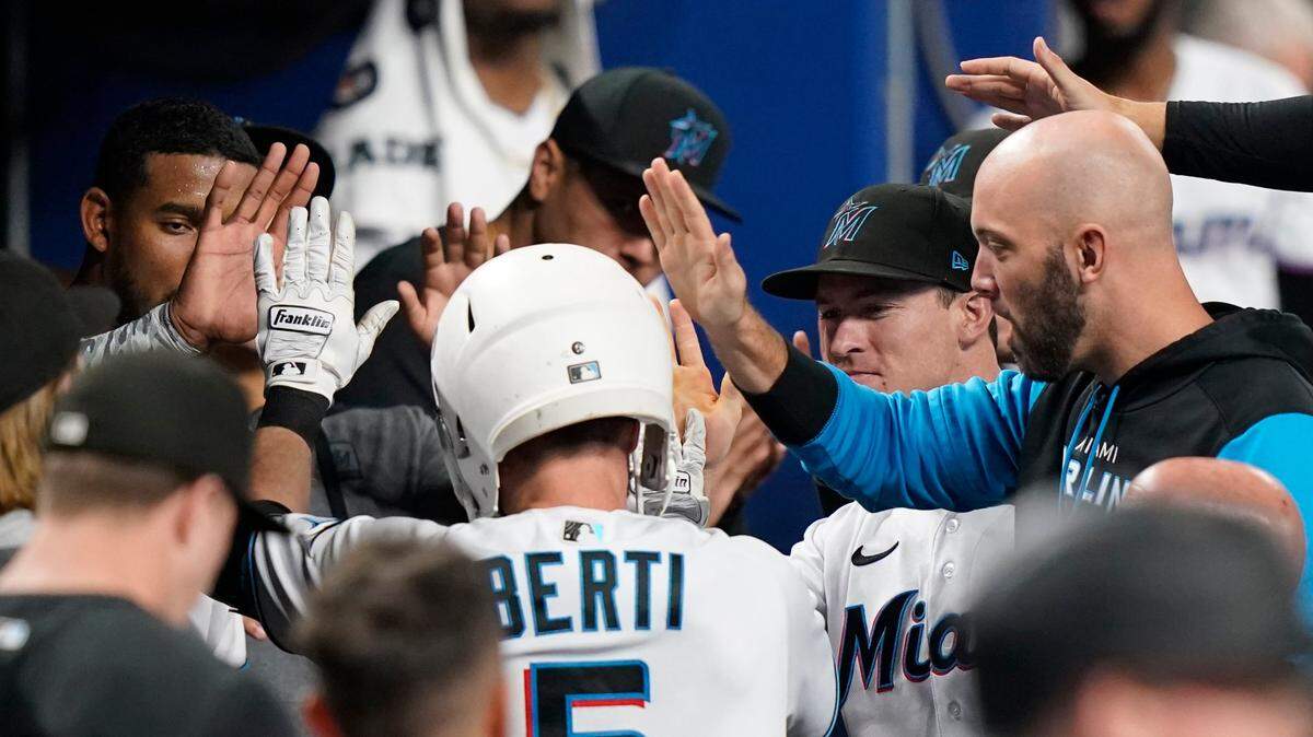 Miami Marlins’ Jon Berti is congratulated after hitting a solo home run during a baseball game against the Chicago Cubs, Monday, Sept. 19, 2022, in Miami. (AP Photo/Lynne Sladky)
