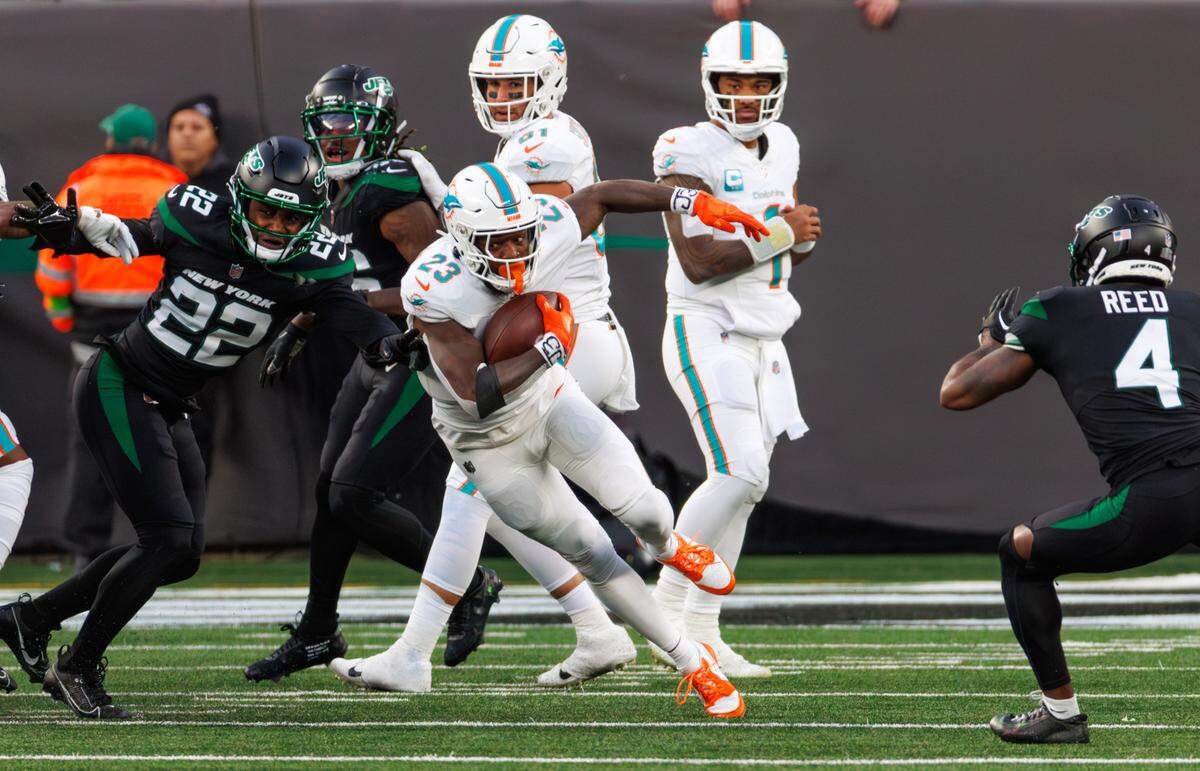Miami Dolphins running back Jeff Wilson Jr. (23) runs with the football during second quarter of an NFL football game against the New York Jets at MetLife Stadium on Friday, Nov. 24, 2023 in East Rutherford, New Jersey.