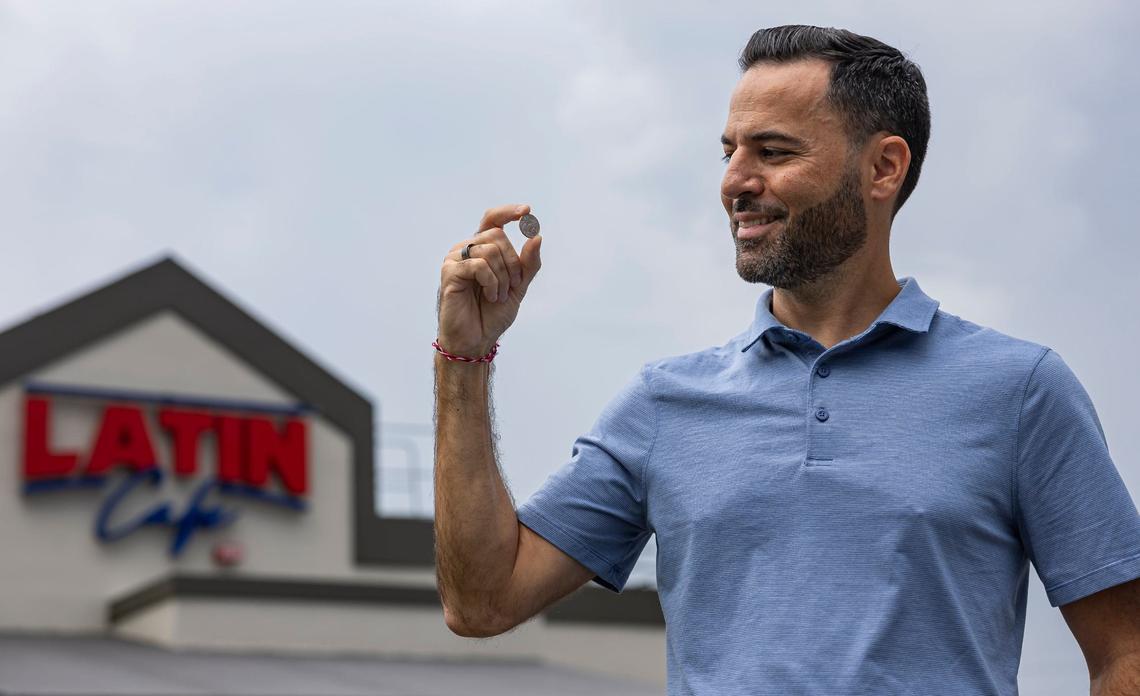 Latin Cafe 2000 owner Eric Castellanos holds a Celia Cruz-themed quarter outside of his restaurant on Monday, Aug. 19, 2024, in Miami, Fla. While supplies last, the restaurant is gifting customers who place orders over $50 and pay with cash a free Celia Cruz quarter. The coin is part of the U.S. Mint’s American Women Quarters Program, which aims to celebrate the accomplishments and contributions made by women of the United States.