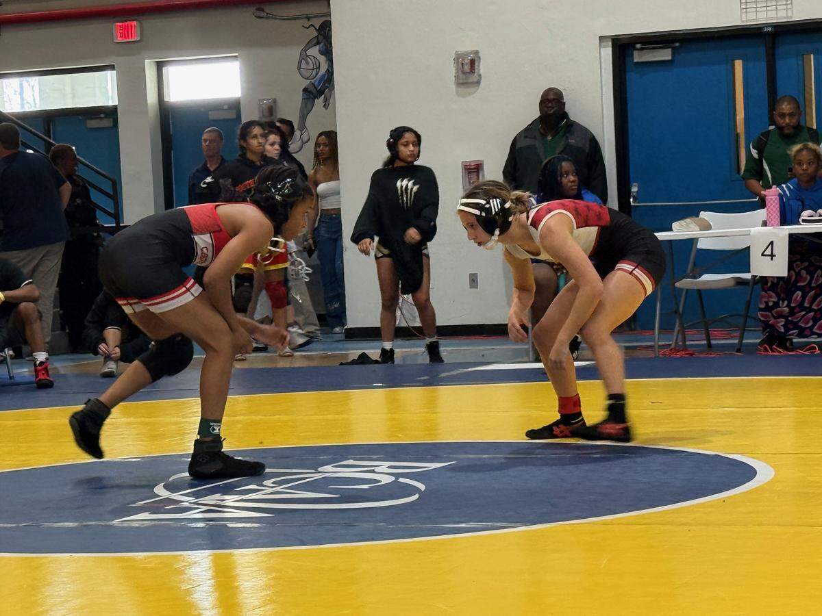 Rosie Kleine of Monarch (right) defeats Alexandra Thomas of Cooper City (left) at 100 pounds by pin at 1:53 during Saturday’s BCAA championships at Dillard High School in Fort Lauderdale.