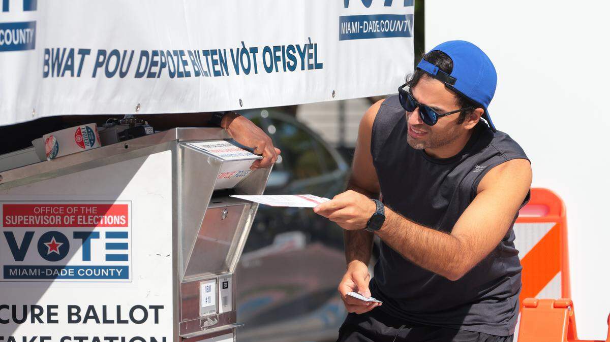 Thomas Olloqui drops off a vote-by-mail ballot during early voting for municipal elections in Miami Beach on Oct. 20, 2025.