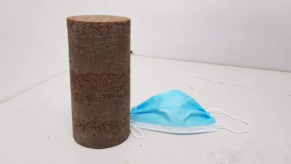 A sample of a recycled road-making material, which blends shredded single-use face masks with processed building rubble, made by engineers at RMIT University in Australia.