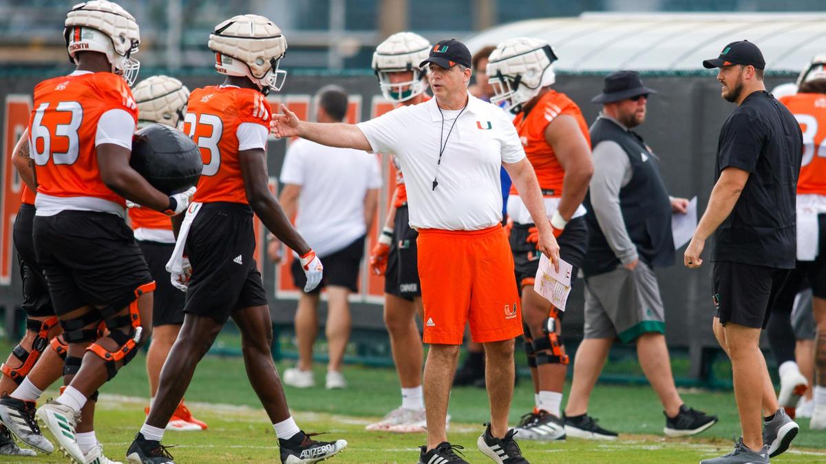 Miami Hurricanes head coach Mario Cristobal talks to his players on the field during spring practice at the University of Miami in Coral Gables, Florida, Saturday, March 4, 2023.